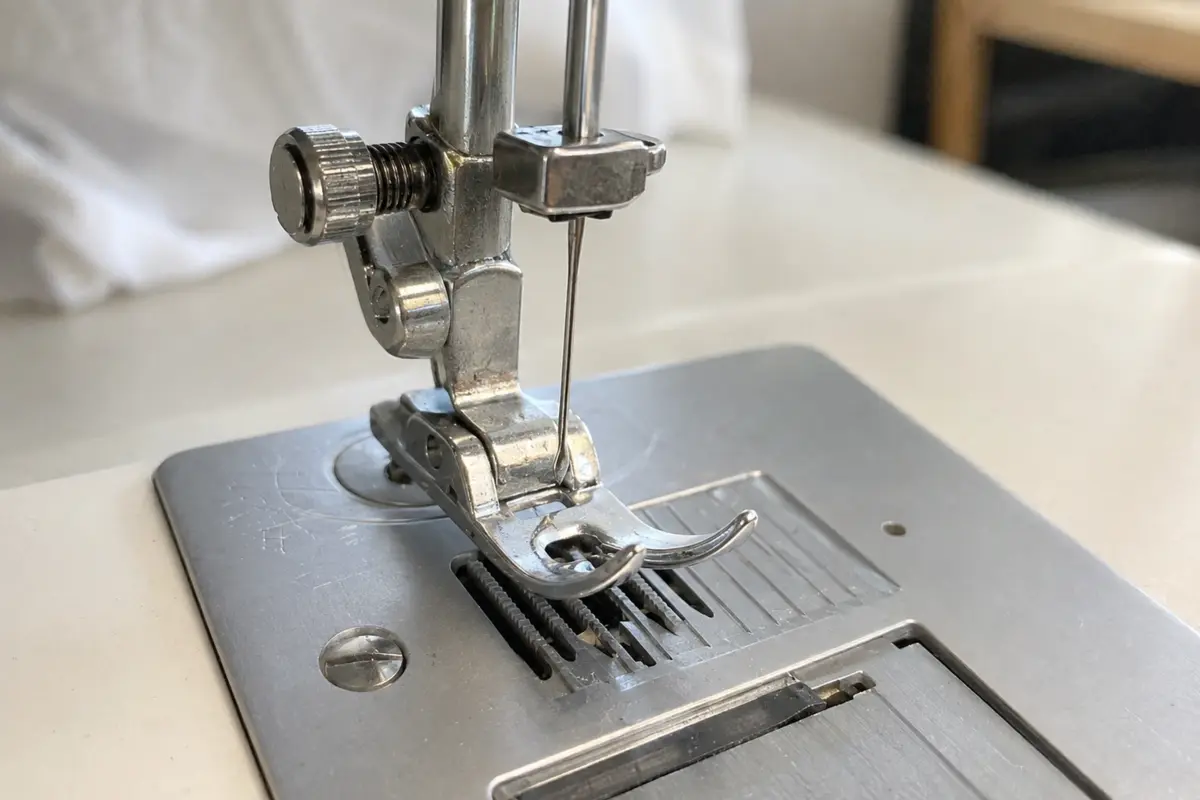 Sewing machine needle and presser foot check Close view of a correctly aligned sewing machine needle, presser foot and needle plate