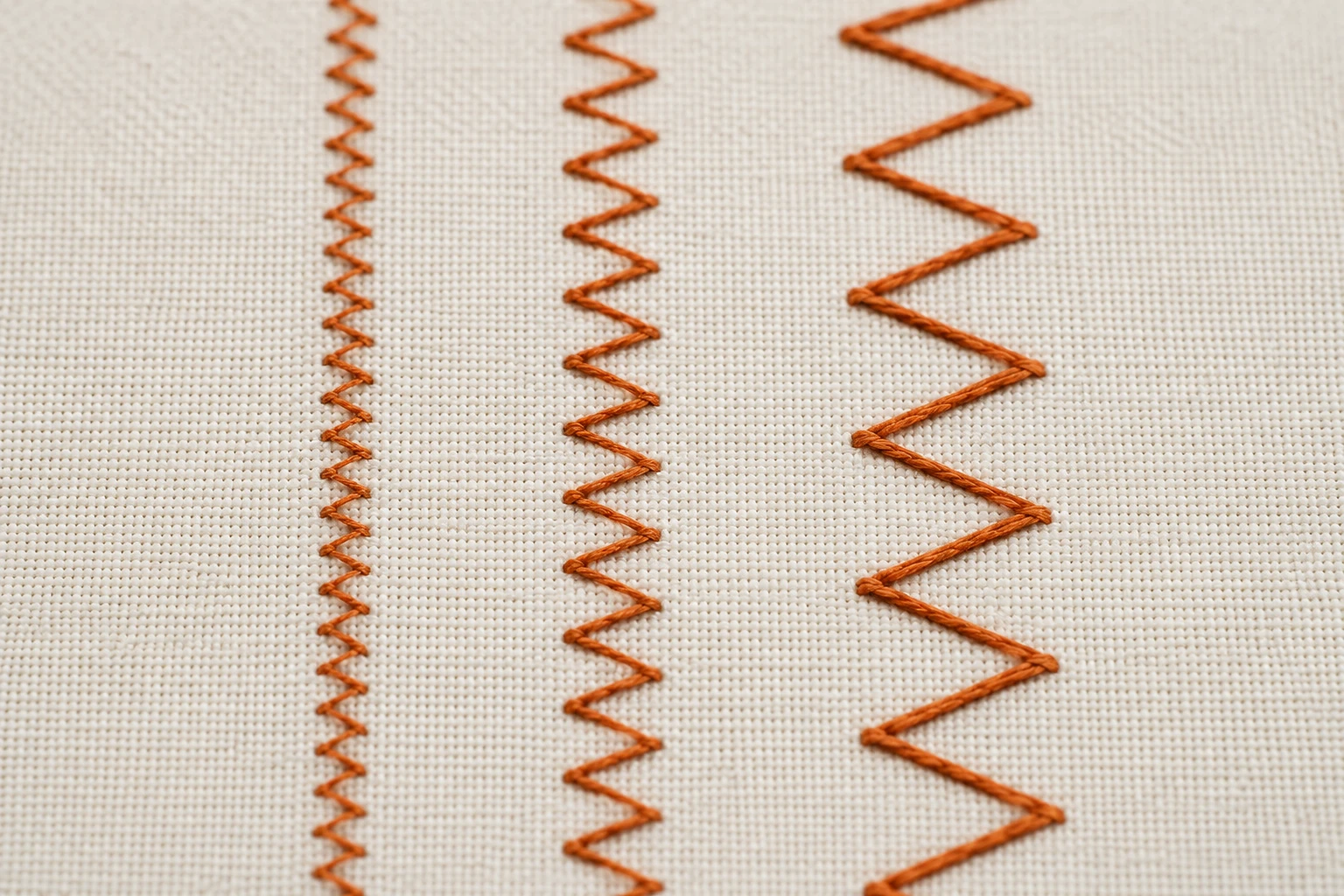 Three orange zigzag rows showing narrow, medium and wide stitch widths