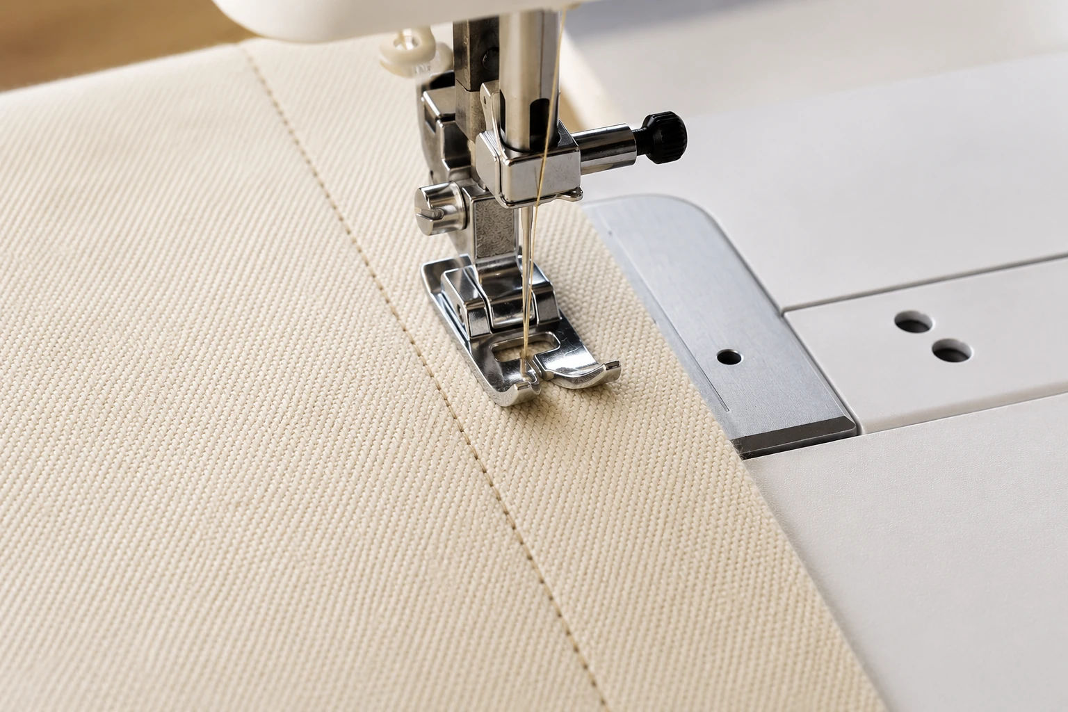 Sewing machine forming a neat straight stitch line behind an all-purpose presser foot
