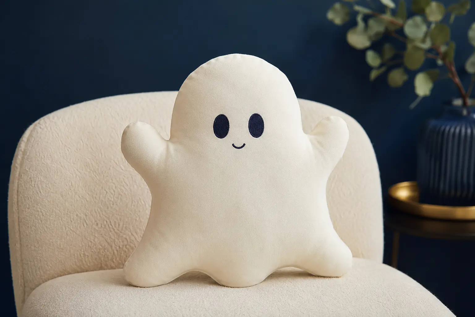 Friendly cream ghost-shaped handmade pillow with embroidered navy face